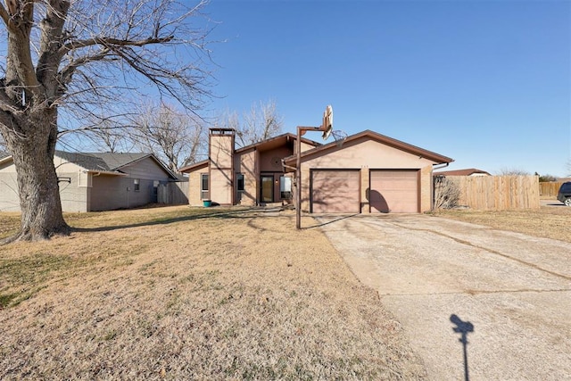 single story home with a front yard and a garage