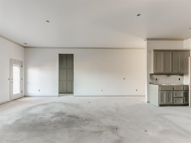 unfurnished living room featuring ornamental molding