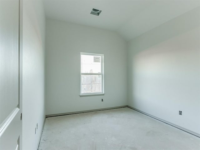 unfurnished room with vaulted ceiling