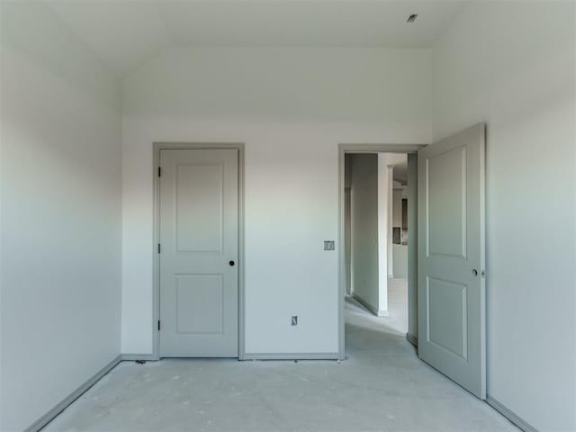 unfurnished bedroom with vaulted ceiling