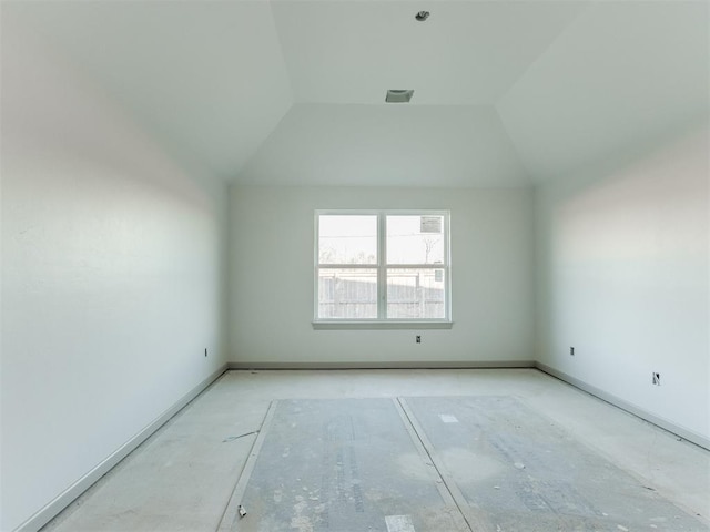 unfurnished room featuring vaulted ceiling