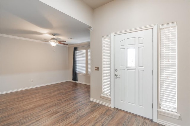 foyer entrance featuring ceiling fan, dark hardwood / wood-style flooring, and crown molding