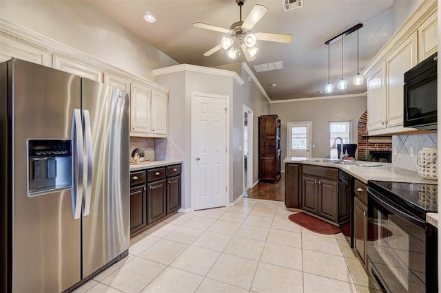 kitchen featuring black appliances, tasteful backsplash, crown molding, cream cabinetry, and dark brown cabinetry