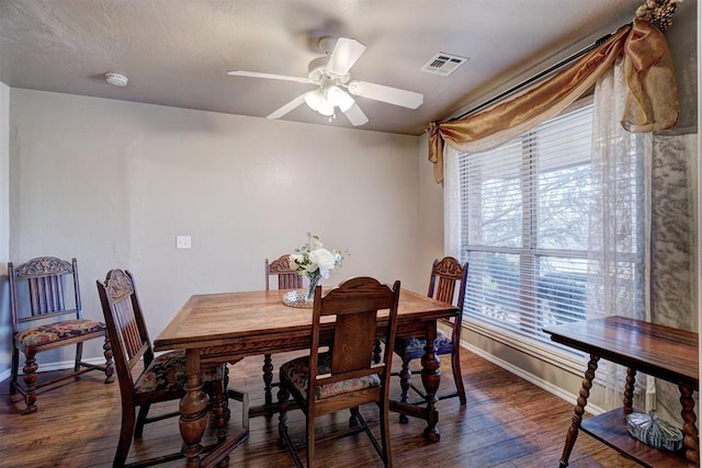 dining room featuring dark hardwood / wood-style flooring, ceiling fan, and a wealth of natural light