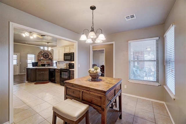 tiled dining area with sink and a chandelier