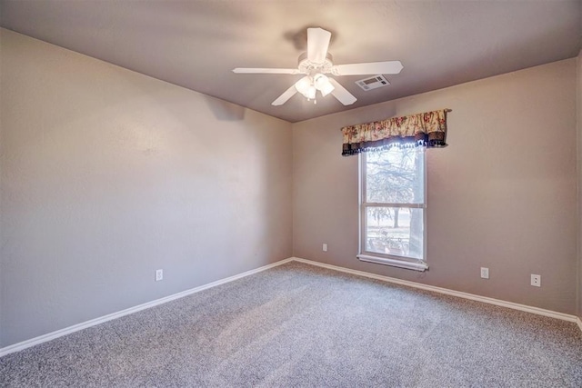 unfurnished room with ceiling fan and carpet