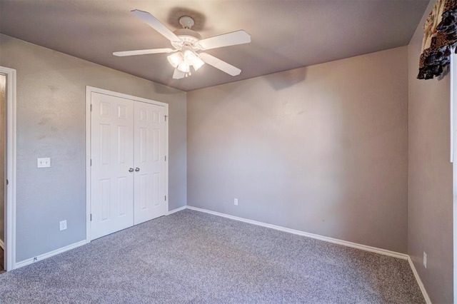 unfurnished bedroom with ceiling fan, a closet, and carpet