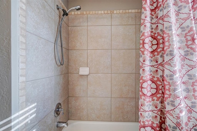 bathroom with shower / bath combination with curtain