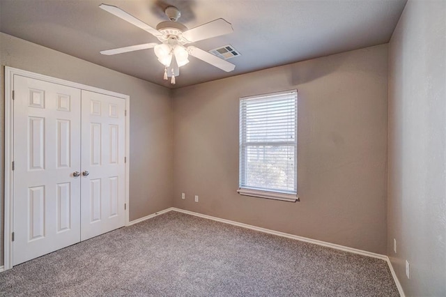 unfurnished bedroom featuring carpet floors, ceiling fan, and a closet