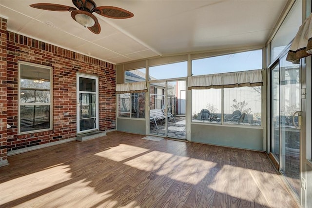 unfurnished sunroom with ceiling fan