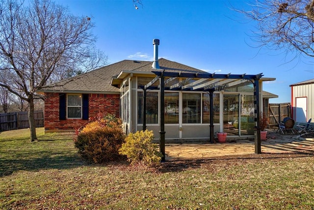 back of house with a patio and a lawn