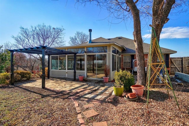 rear view of property featuring a pergola and a sunroom