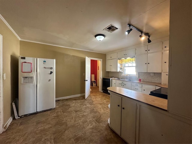 kitchen featuring white refrigerator with ice dispenser, track lighting, white cabinetry, ornamental molding, and sink