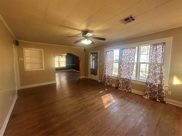 unfurnished room featuring ceiling fan, dark hardwood / wood-style flooring, built in features, and crown molding