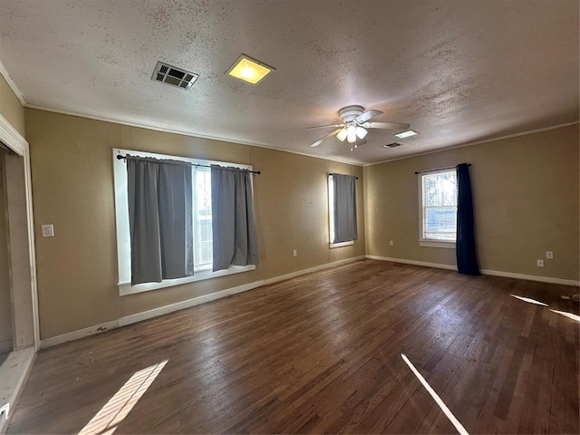 empty room with ceiling fan, crown molding, a wealth of natural light, and wood-type flooring