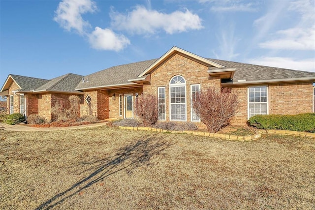 ranch-style home featuring a front yard