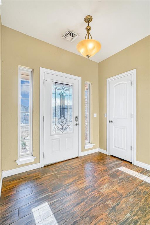 entrance foyer with dark hardwood / wood-style floors