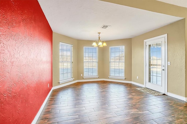 unfurnished dining area with a notable chandelier