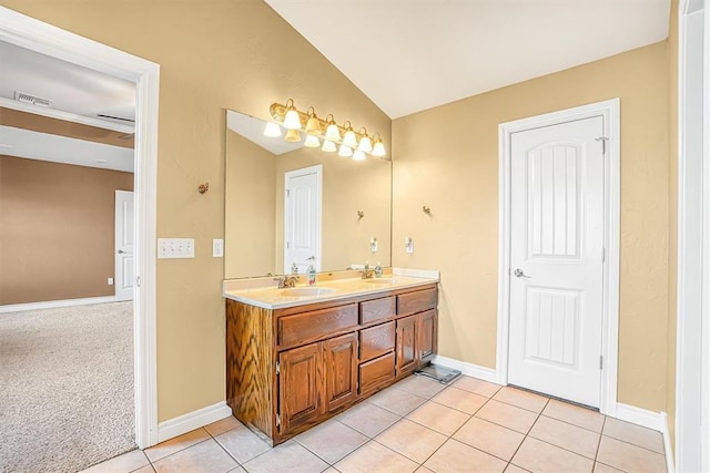 bathroom featuring crown molding, lofted ceiling, tile patterned floors, and vanity