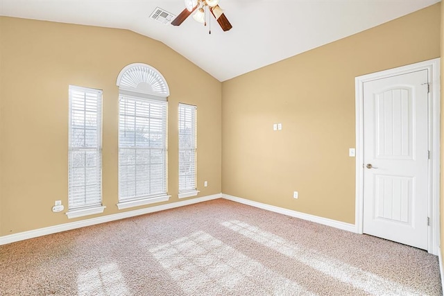 carpeted empty room featuring ceiling fan and lofted ceiling