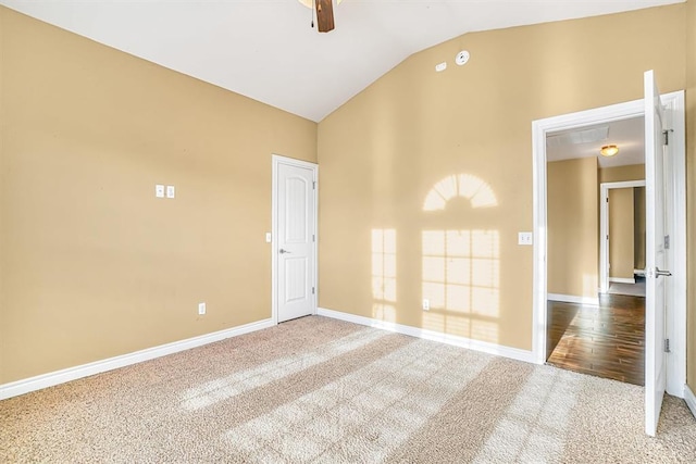 carpeted spare room with vaulted ceiling and ceiling fan