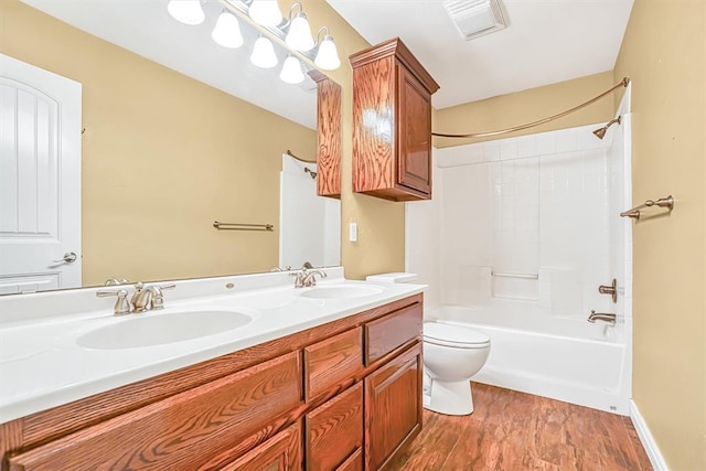 full bathroom featuring toilet,  shower combination, hardwood / wood-style flooring, and vanity