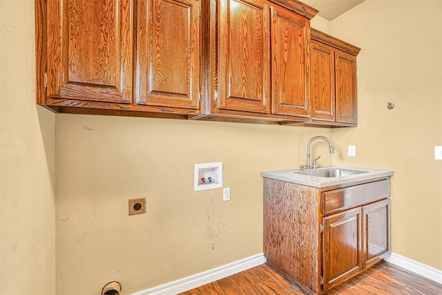 laundry room with hookup for an electric dryer, wood-type flooring, washer hookup, cabinets, and sink