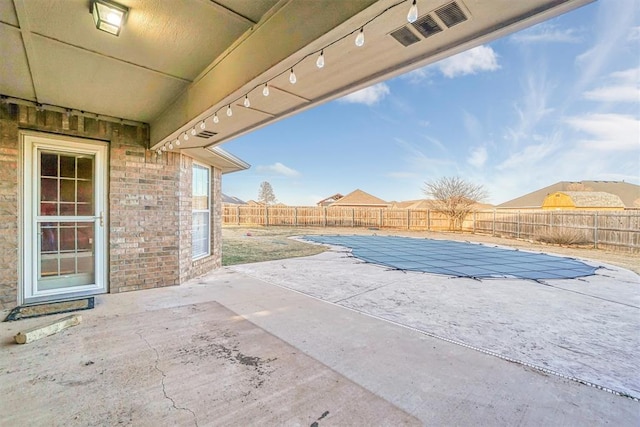 view of patio / terrace with a covered pool