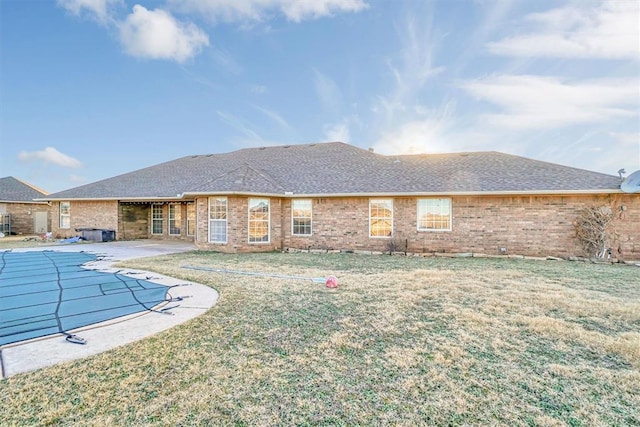 back of house with a patio area and a yard