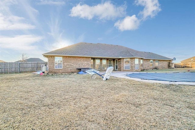 back of house featuring a covered pool and a patio