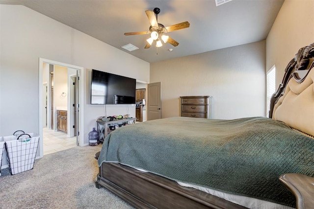 bedroom with lofted ceiling, ensuite bath, ceiling fan, and light colored carpet