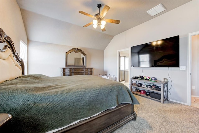 bedroom with ceiling fan, ensuite bathroom, lofted ceiling, and carpet flooring