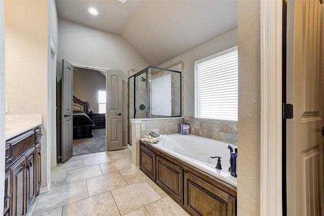 bathroom featuring shower with separate bathtub, vaulted ceiling, tile patterned flooring, and a wealth of natural light