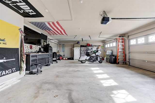 garage with a garage door opener and electric panel