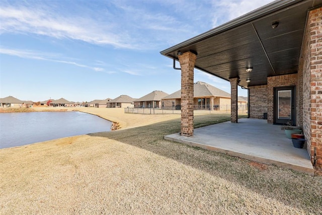 view of yard with a patio area and a water view