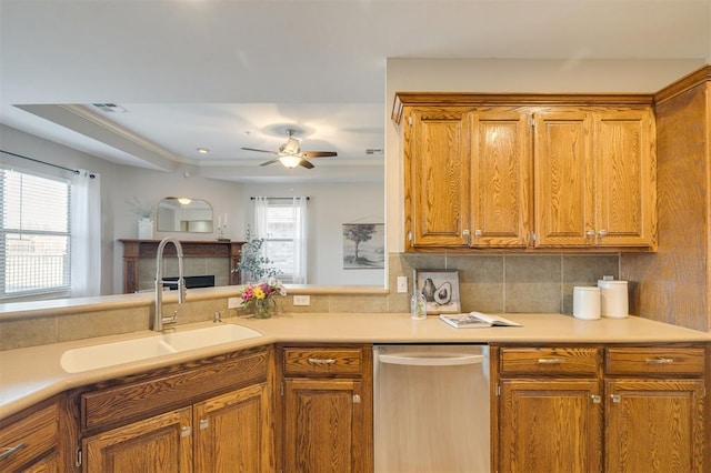 kitchen with sink, ceiling fan, backsplash, and kitchen peninsula