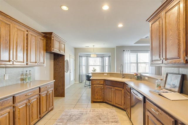 kitchen featuring sink, light tile patterned flooring, stainless steel dishwasher, decorative backsplash, and pendant lighting