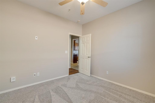 carpeted empty room with ceiling fan