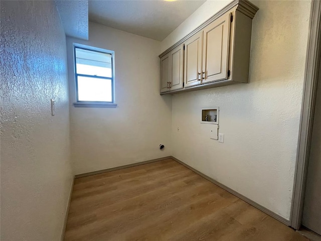 laundry room with light hardwood / wood-style floors, cabinets, and hookup for a washing machine