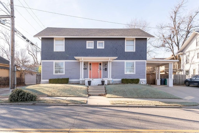 view of front facade featuring a front lawn and a carport