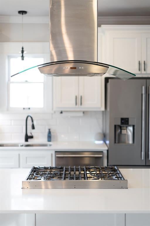 kitchen featuring island range hood, hanging light fixtures, stainless steel fridge with ice dispenser, backsplash, and white cabinetry