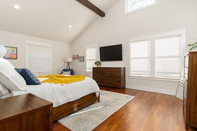 bedroom with high vaulted ceiling, beamed ceiling, and hardwood / wood-style floors