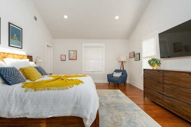 bedroom featuring vaulted ceiling and dark hardwood / wood-style flooring