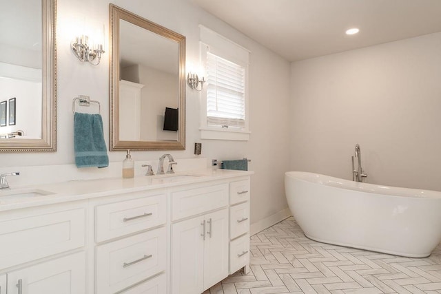 bathroom with a tub and vanity