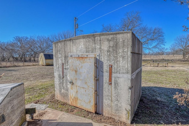 view of outdoor structure with a rural view