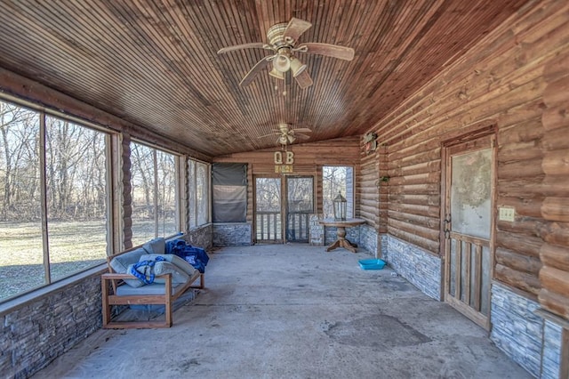 unfurnished sunroom with vaulted ceiling, wooden ceiling, and ceiling fan