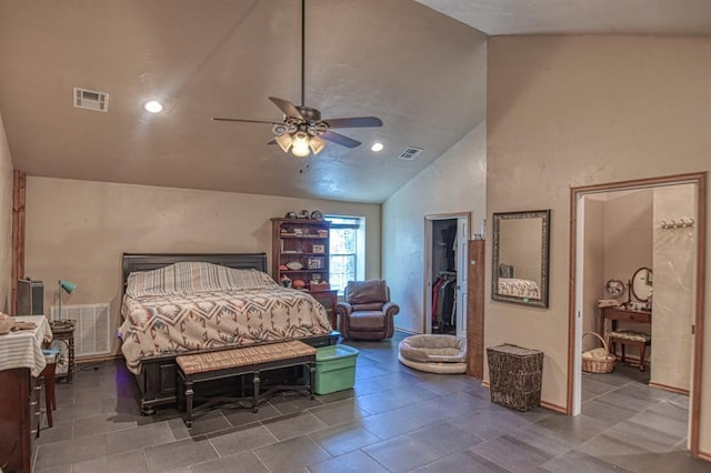 bedroom featuring ceiling fan, lofted ceiling, and a spacious closet