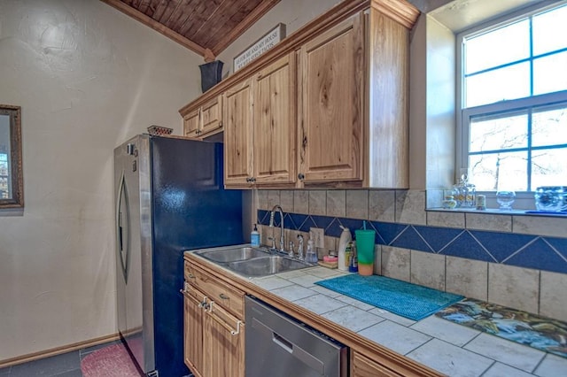 kitchen featuring sink, crown molding, tile countertops, dishwasher, and backsplash