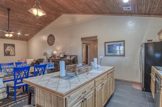 kitchen with wood ceiling, tile counters, a center island, and vaulted ceiling