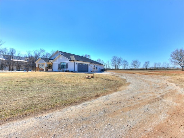 view of front of house with a garage and a front yard